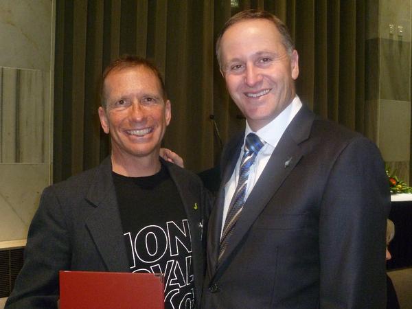 Peter Bilous collects his award from PM John Key